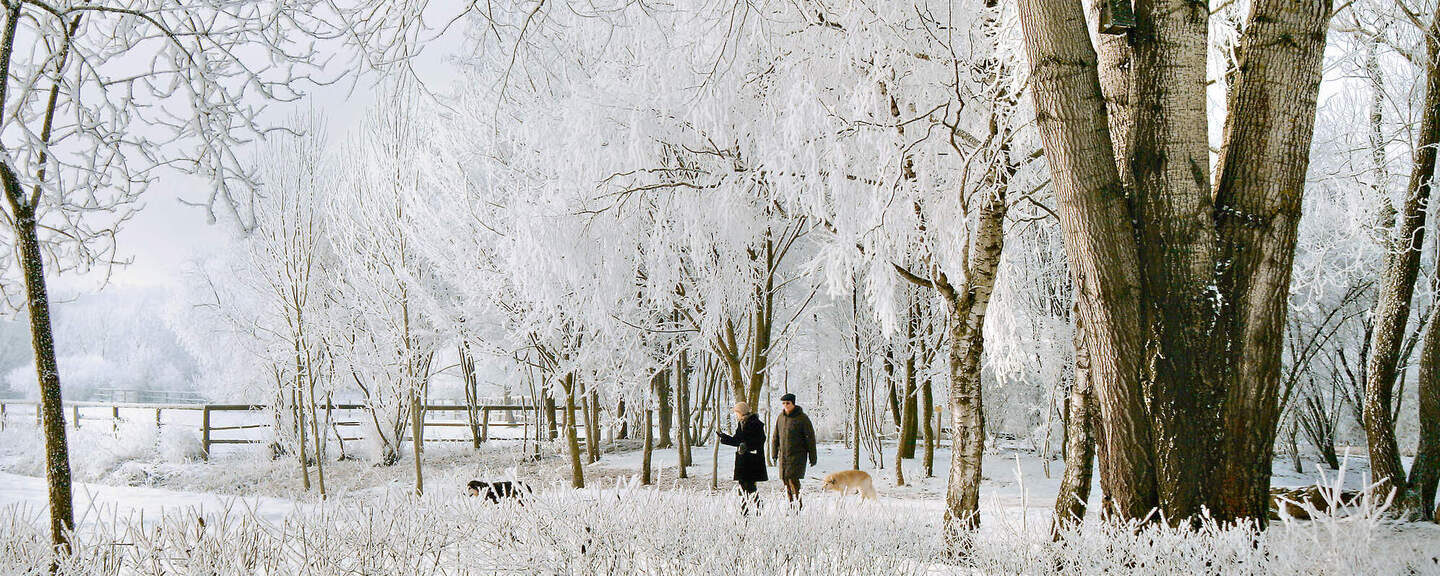 Ein paar geht in der verschneite Umgebung von Bad Birnbach spazieren